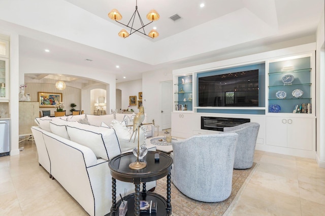 216 Summa St, West Palm Beach, FL 33405 - living room featuring a chandelier, arched walkways, recessed lighting, and built in shelves