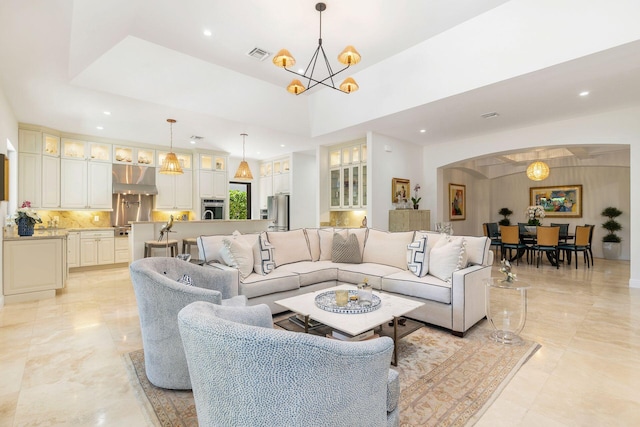 216 Summa St, West Palm Beach, FL 33405 - living area with a chandelier, arched walkways, recessed lighting, and light marble finish floors