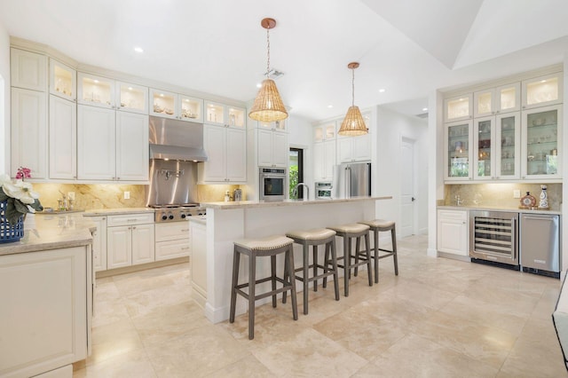 216 Summa St, West Palm Beach, FL 33405 - kitchen with beverage cooler, stainless steel appliances, tasteful backsplash, recessed lighting, and a kitchen breakfast bar