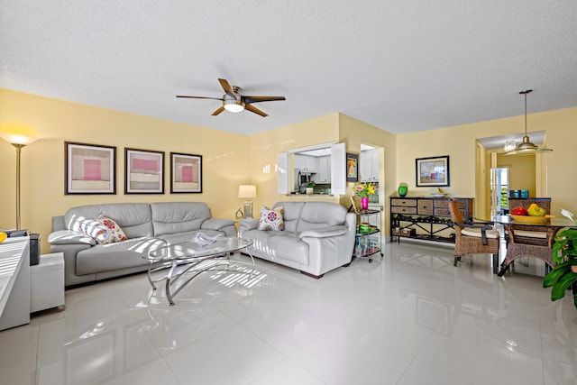310 Farnham M Unit 310, Deerfield Beach, FL 33442 - living room featuring ceiling fan, tile patterned flooring, and a textured ceiling