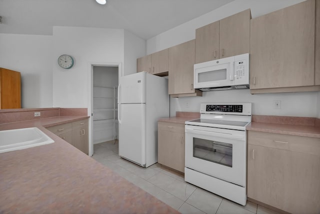 511 SW Treasure Cv, Port Saint Lucie, FL 34986 - kitchen with white appliances, light brown cabinets, and light countertops