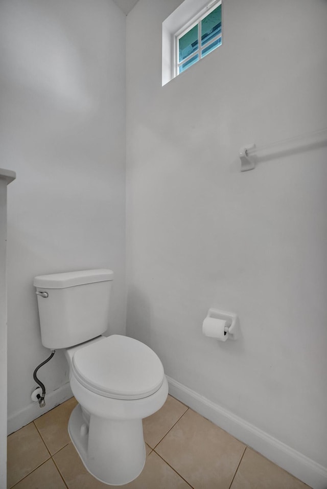 511 SW Treasure Cv, Port Saint Lucie, FL 34986 - half bathroom with toilet and tile patterned floors