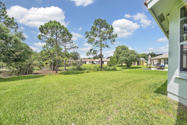511 SW Treasure Cv, Port Saint Lucie, FL 34986 - view of grassy yard with a patio area and a residential view