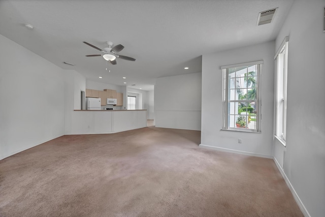 511 SW Treasure Cv, Port Saint Lucie, FL 34986 - unfurnished living room featuring a ceiling fan, carpet flooring, and recessed lighting