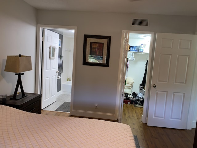 2975 SW 22nd Ave Unit 2010, Delray Beach, FL 33445 - bedroom with a spacious closet, wood finished floors, a closet, and connected bathroom
