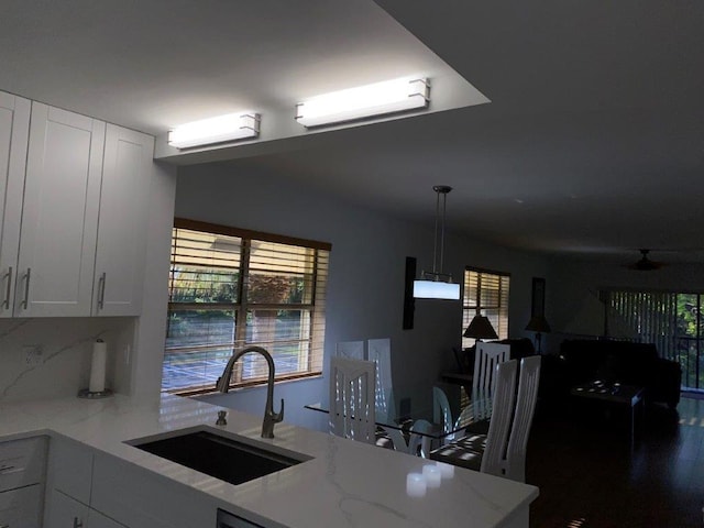 2975 SW 22nd Ave Unit 2010, Delray Beach, FL 33445 - kitchen with light stone countertops, white cabinets, plenty of natural light, and open floor plan