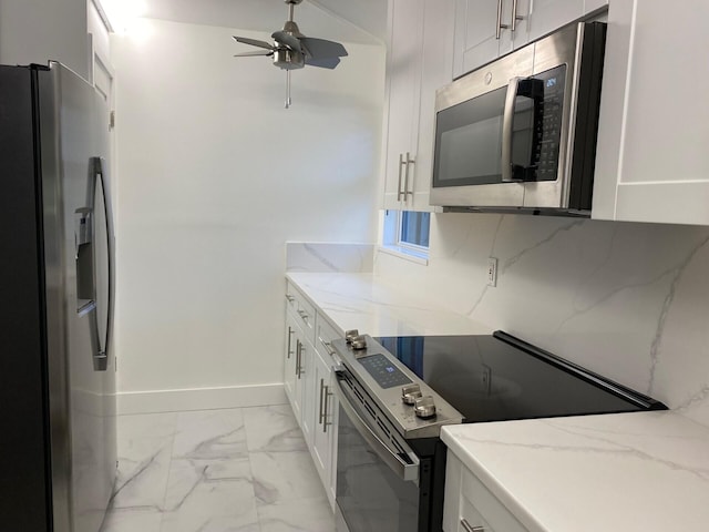 2975 SW 22nd Ave Unit 2010, Delray Beach, FL 33445 - kitchen featuring appliances with stainless steel finishes, light marble finish flooring, light stone counters, and white cabinetry