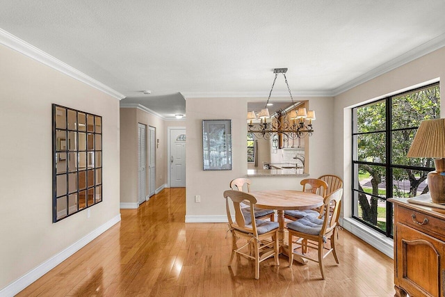 45 Stratford Ln Unit B, Boynton Beach, FL 33436 - dining space featuring light wood-style flooring, a chandelier, and crown molding