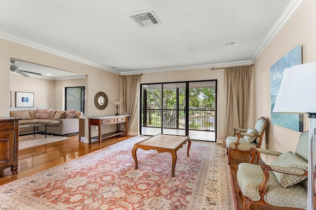 45 Stratford Ln Unit B, Boynton Beach, FL 33436 - living area featuring wood finished floors, ornamental molding, and a ceiling fan