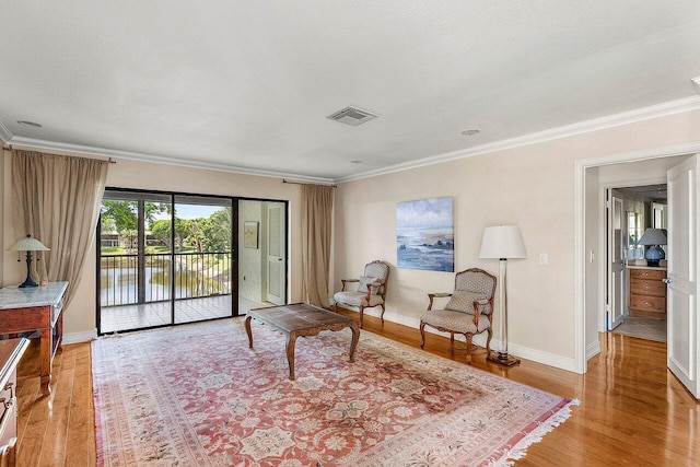 45 Stratford Ln Unit B, Boynton Beach, FL 33436 - living area with light wood-type flooring, crown molding, and a water view