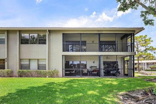 45 Stratford Ln Unit B, Boynton Beach, FL 33436 - rear view of property featuring stucco siding and a lawn