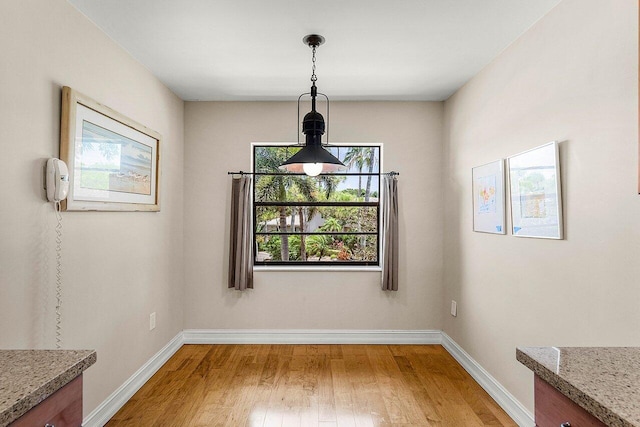 45 Stratford Ln Unit B, Boynton Beach, FL 33436 - unfurnished dining area with light wood-style flooring and baseboards