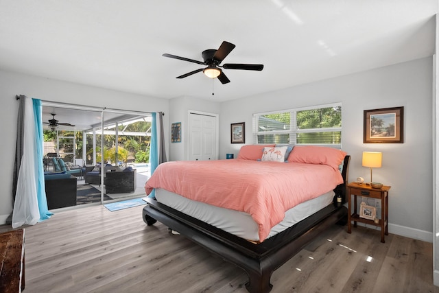 4931 SE Pompano Ter, Stuart, FL 34997 - bedroom with access to outside, wood finished floors, a closet, and a ceiling fan