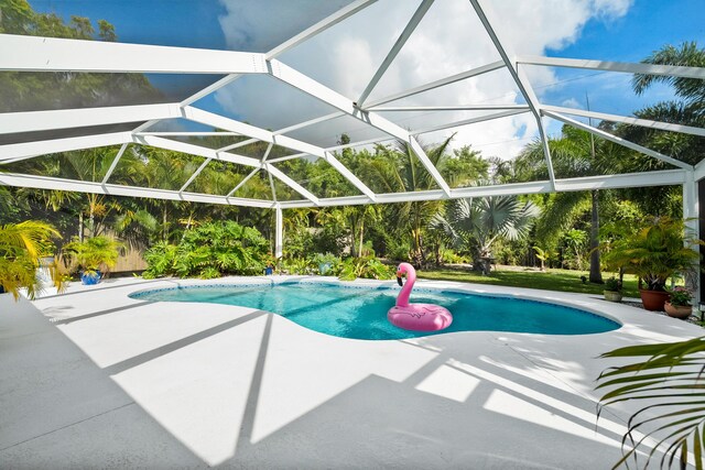 4931 SE Pompano Ter, Stuart, FL 34997 - swimming pool with a patio area and a lanai