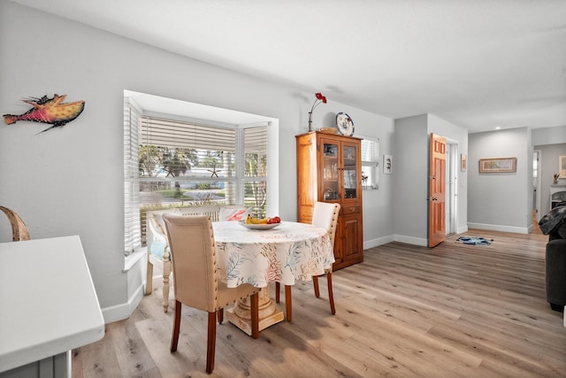 4931 SE Pompano Ter, Stuart, FL 34997 - dining area with light wood-style floors and baseboards