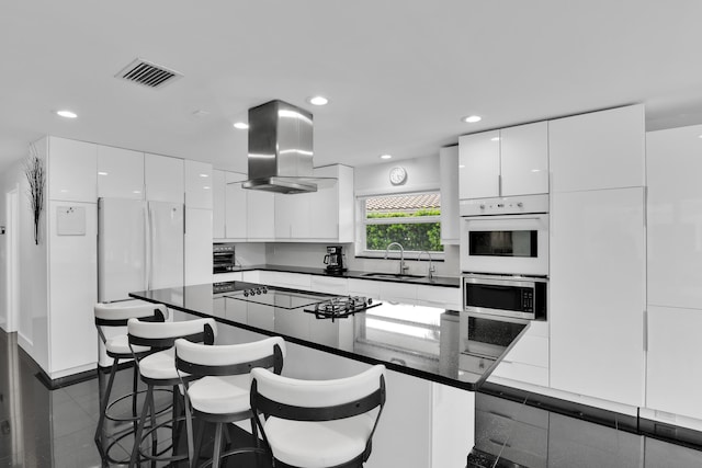 7197 Encina Ln, Boca Raton, FL 33433 - kitchen featuring dark countertops, island range hood, modern cabinets, and recessed lighting