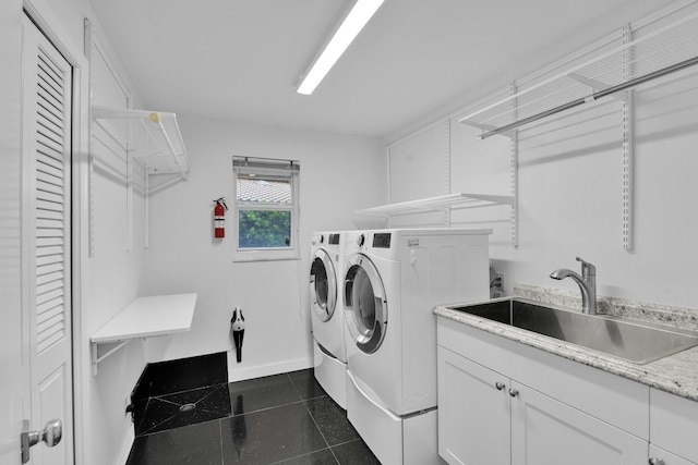 7197 Encina Ln, Boca Raton, FL 33433 - laundry area with independent washer and dryer, dark tile patterned flooring, and cabinet space