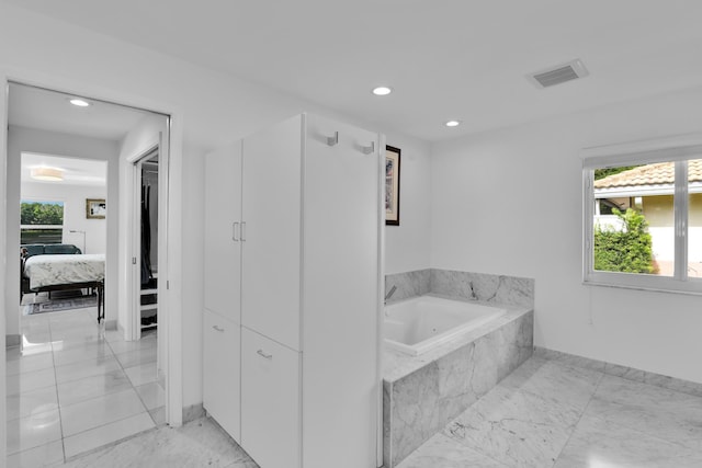 7197 Encina Ln, Boca Raton, FL 33433 - ensuite bathroom featuring marble look tiles, a garden tub, and recessed lighting
