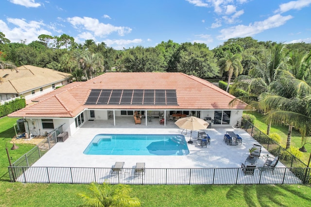 7197 Encina Ln, Boca Raton, FL 33433 - back of house with a tiled roof, a fenced backyard, a patio area, and solar panels