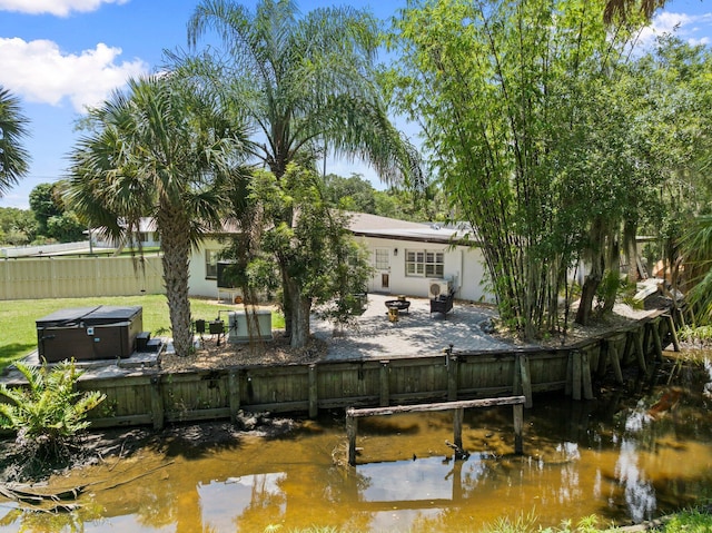1400 Parkland Blvd, Fort Pierce, FL 34982 - back of property featuring a patio area, a hot tub, and stucco siding