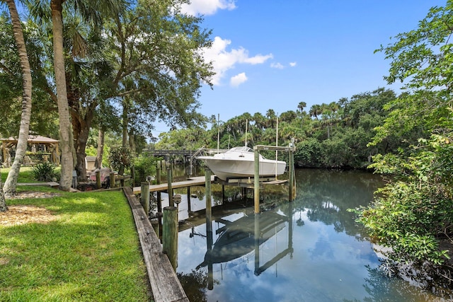 1400 Parkland Blvd, Fort Pierce, FL 34982 - dock area with boat lift, a water view, and a lawn