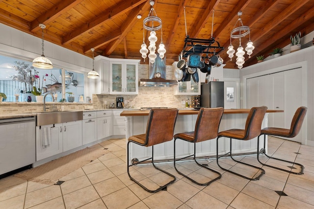 1400 Parkland Blvd, Fort Pierce, FL 34982 - kitchen with wooden ceiling, stainless steel appliances, wall chimney range hood, light tile patterned flooring, and tasteful backsplash