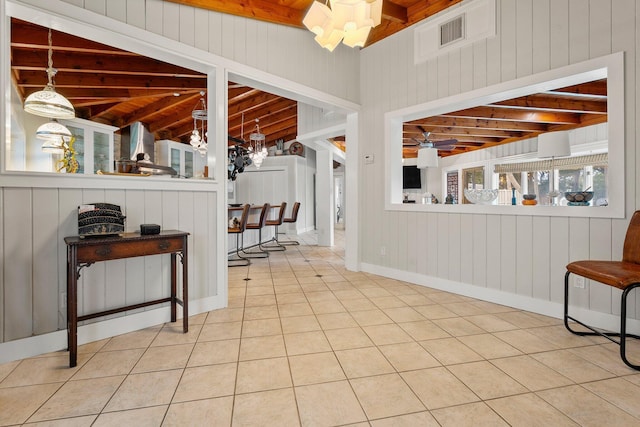 1400 Parkland Blvd, Fort Pierce, FL 34982 - interior space featuring a wooden ceiling with exposed beams, tile patterned floors, wood walls, and a chandelier