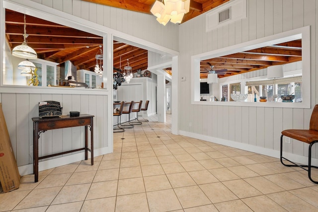 1400 Parkland Blvd, Fort Pierce, FL 34982 - living area with wooden walls, tile patterned floors, a wooden ceiling with exposed beams, and a chandelier