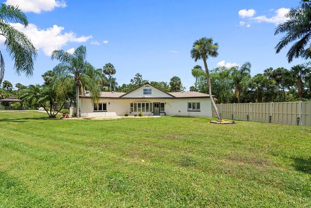 1400 Parkland Blvd, Fort Pierce, FL 34982 - rear view of house featuring stucco siding