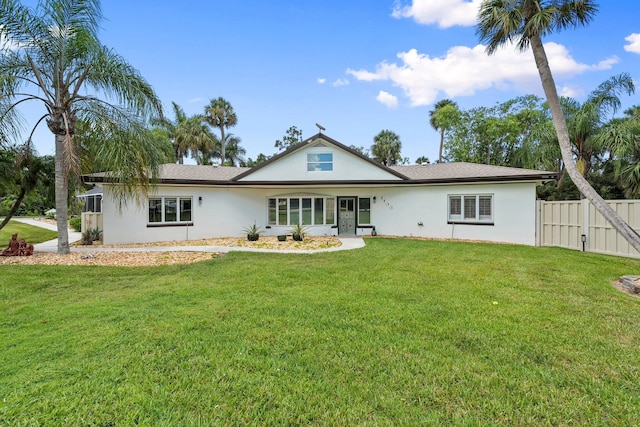 1400 Parkland Blvd, Fort Pierce, FL 34982 - rear view of house featuring stucco siding and a gate