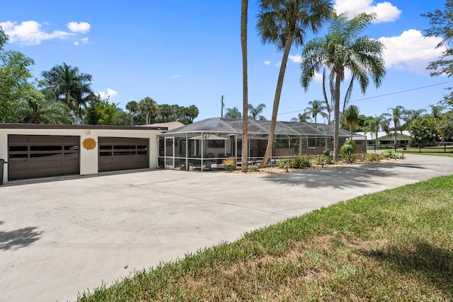 1400 Parkland Blvd, Fort Pierce, FL 34982 - view of front facade with a garage, concrete driveway, and glass enclosure