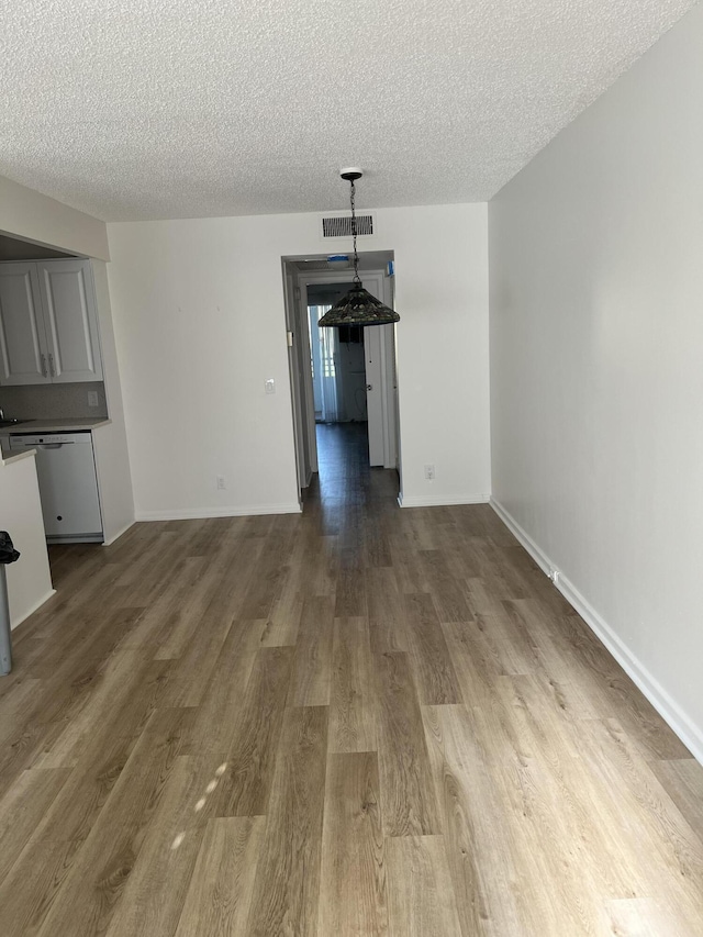 2072 Cornwall D, Boca Raton, FL 33434 - unfurnished dining area with wood finished floors and a textured ceiling