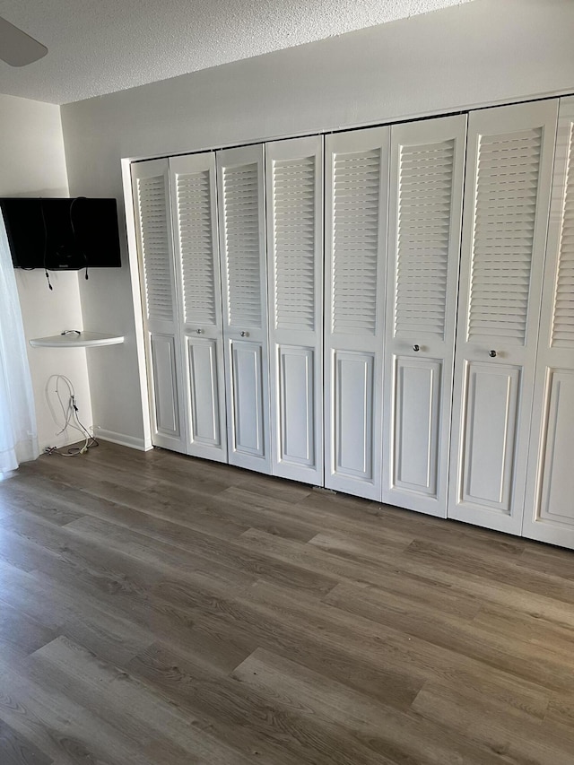 2072 Cornwall D, Boca Raton, FL 33434 - unfurnished bedroom featuring dark wood-style flooring and a closet