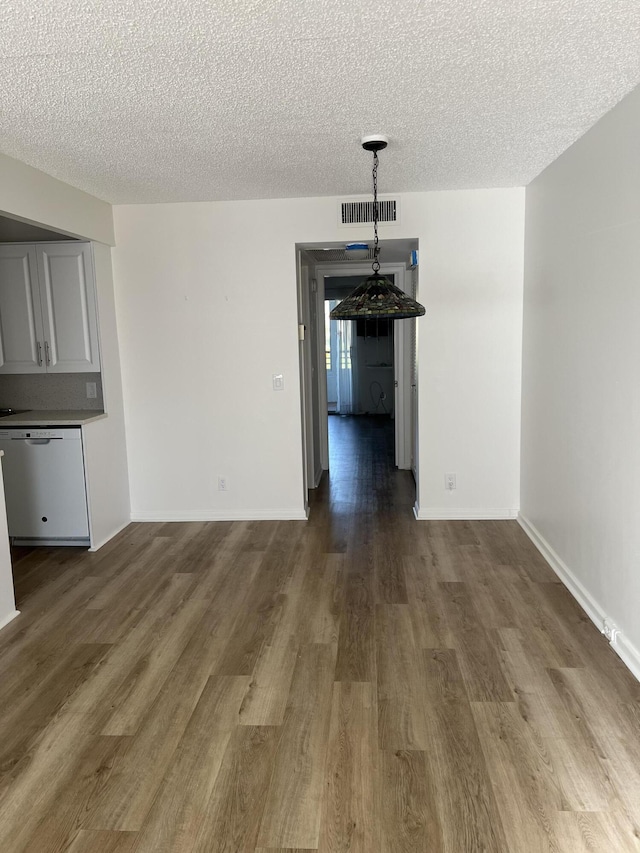 2072 Cornwall D, Boca Raton, FL 33434 - unfurnished dining area with wood finished floors and a textured ceiling