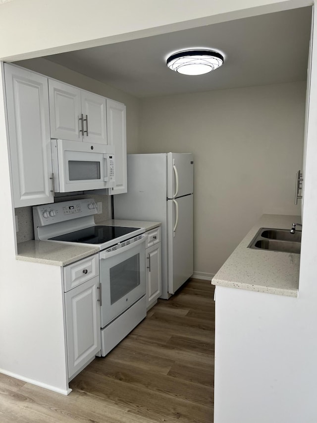 2072 Cornwall D, Boca Raton, FL 33434 - kitchen featuring white appliances, wood finished floors, and white cabinets