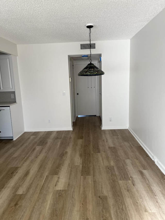 2072 Cornwall D, Boca Raton, FL 33434 - unfurnished dining area with wood finished floors and a textured ceiling