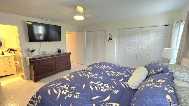 6140 Stanley Ln, Delray Beach, FL 33484 - bedroom featuring multiple closets, light tile patterned floors, a ceiling fan, and connected bathroom
