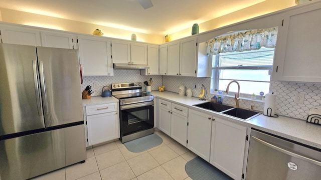 6140 Stanley Ln, Delray Beach, FL 33484 - kitchen featuring appliances with stainless steel finishes, light tile patterned floors, under cabinet range hood, light countertops, and backsplash