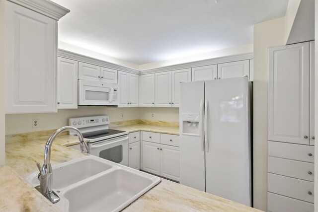 5623 SE Foxcross Pl, Stuart, FL 34997 - kitchen with white appliances, light countertops, and white cabinetry