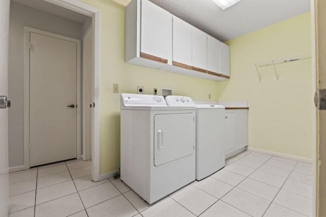 5623 SE Foxcross Pl, Stuart, FL 34997 - laundry room featuring cabinet space, light tile patterned floors, and washing machine and dryer