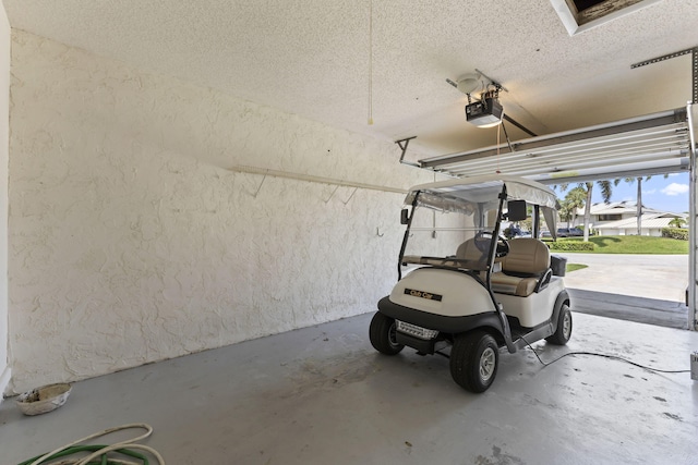 5623 SE Foxcross Pl, Stuart, FL 34997 - garage featuring a garage door opener and a textured wall