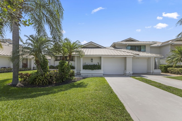 5623 SE Foxcross Pl, Stuart, FL 34997 - view of front of property with a standing seam roof, a metal roof, concrete driveway, a front yard, and an attached garage
