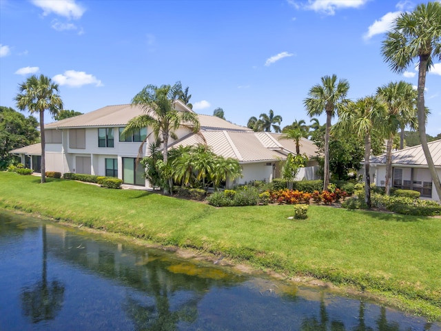 5623 SE Foxcross Pl, Stuart, FL 34997 - view of front of property with a water view, a metal roof, and a front lawn