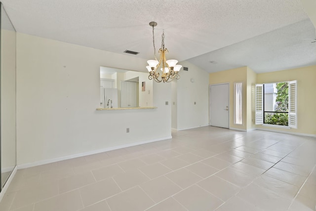 5623 SE Foxcross Pl, Stuart, FL 34997 - unfurnished room featuring a chandelier, a textured ceiling, vaulted ceiling, and light tile patterned floors