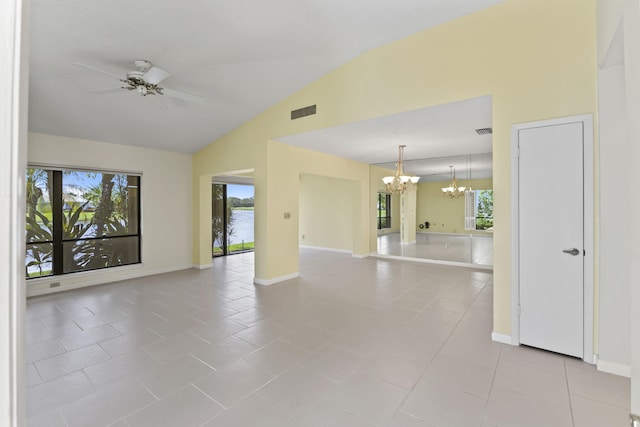 5623 SE Foxcross Pl, Stuart, FL 34997 - spare room with a chandelier, ceiling fan, lofted ceiling, healthy amount of natural light, and light tile patterned floors