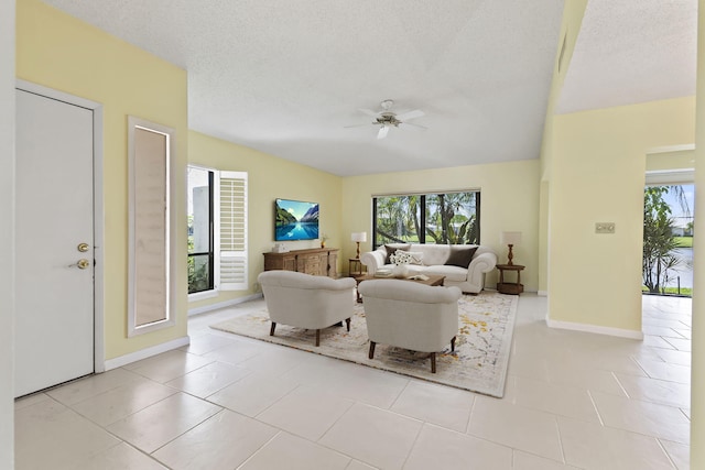 5623 SE Foxcross Pl, Stuart, FL 34997 - living room with ceiling fan, healthy amount of natural light, light tile patterned floors, and a textured ceiling