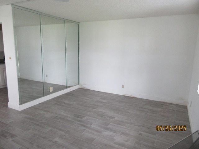 241 Normandy F, Delray Beach, FL 33484 - unfurnished bedroom featuring wood finished floors and a closet