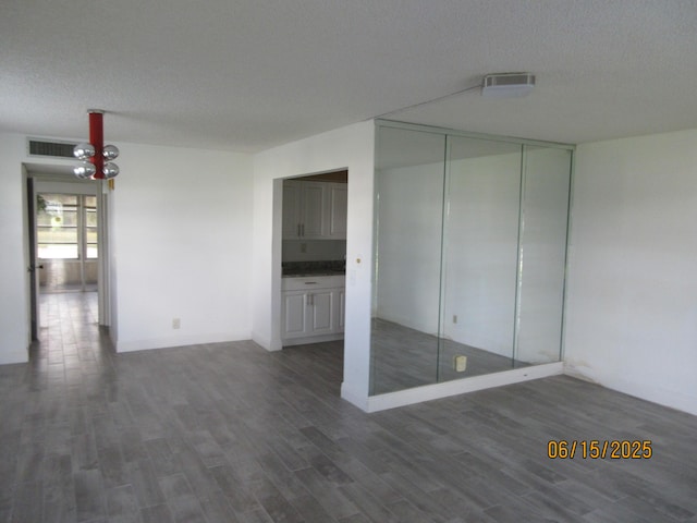 241 Normandy F, Delray Beach, FL 33484 - spare room with wood finished floors and a textured ceiling