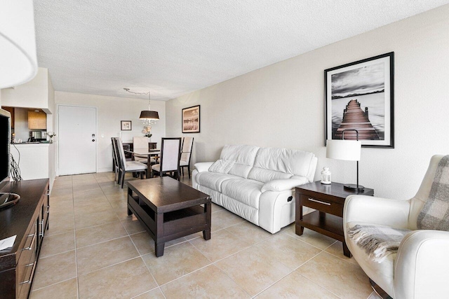 1830 Embassy Dr Unit 401, West Palm Beach, FL 33401 - living room with light tile patterned floors and a textured ceiling