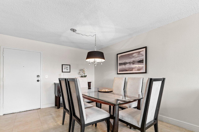 1830 Embassy Dr Unit 401, West Palm Beach, FL 33401 - dining space with a textured ceiling, light tile patterned floors, and a chandelier